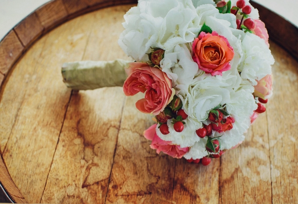 Florist's workbench with scissors, ribbon and fresh stems laid out