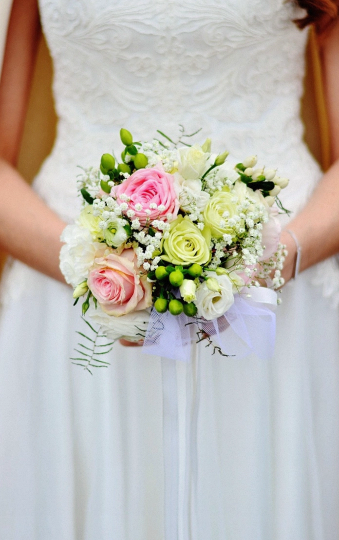 Florist wrapping a bouquet in kraft paper